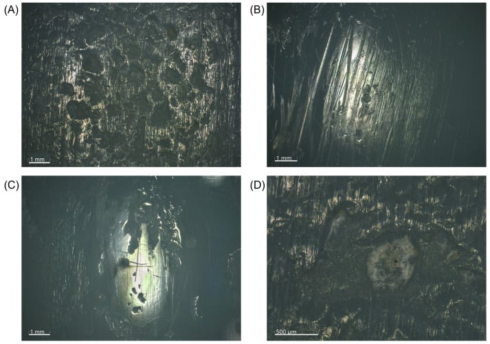 Four microscopy panels (A-D) of retrieved polyethylene showing pitting, parallel scratching, a burnished area and debris within a pit, with scale bars.