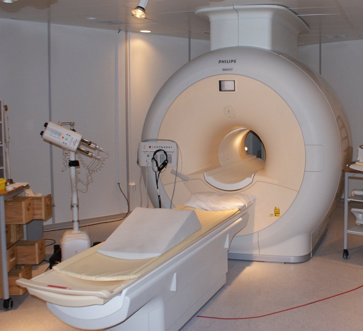 A modern Philips MRI scanner in a hospital imaging room.