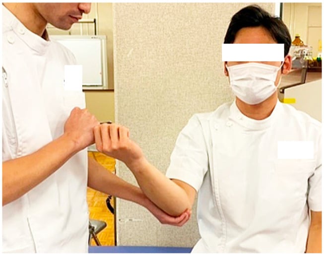 Photograph demonstrating the moving valgus stress test of the elbow