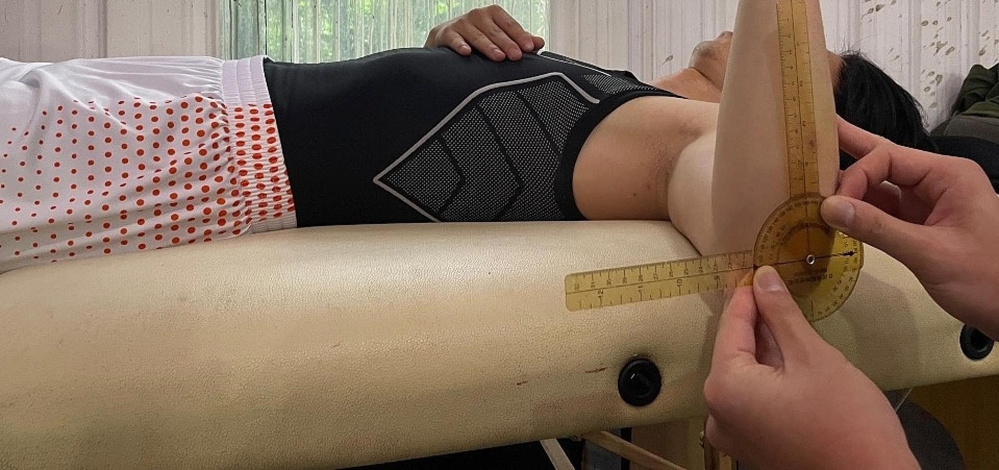 Setup for shoulder rotation measurement with the patient supine and the anterior arm perpendicular to the couch
