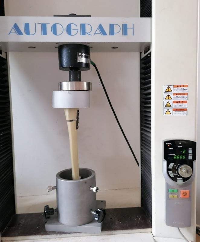 Synthetic proximal tibial fracture construct mounted vertically for axial compression testing