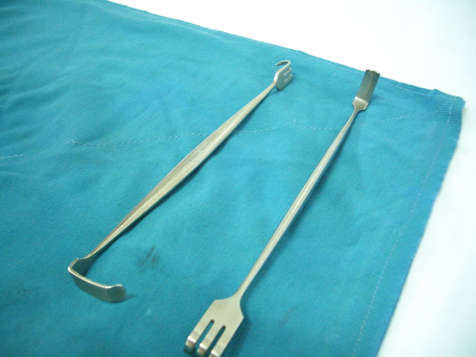 Pair of double-ended Miller-Senn retractors showing right-angled blades and rake ends.