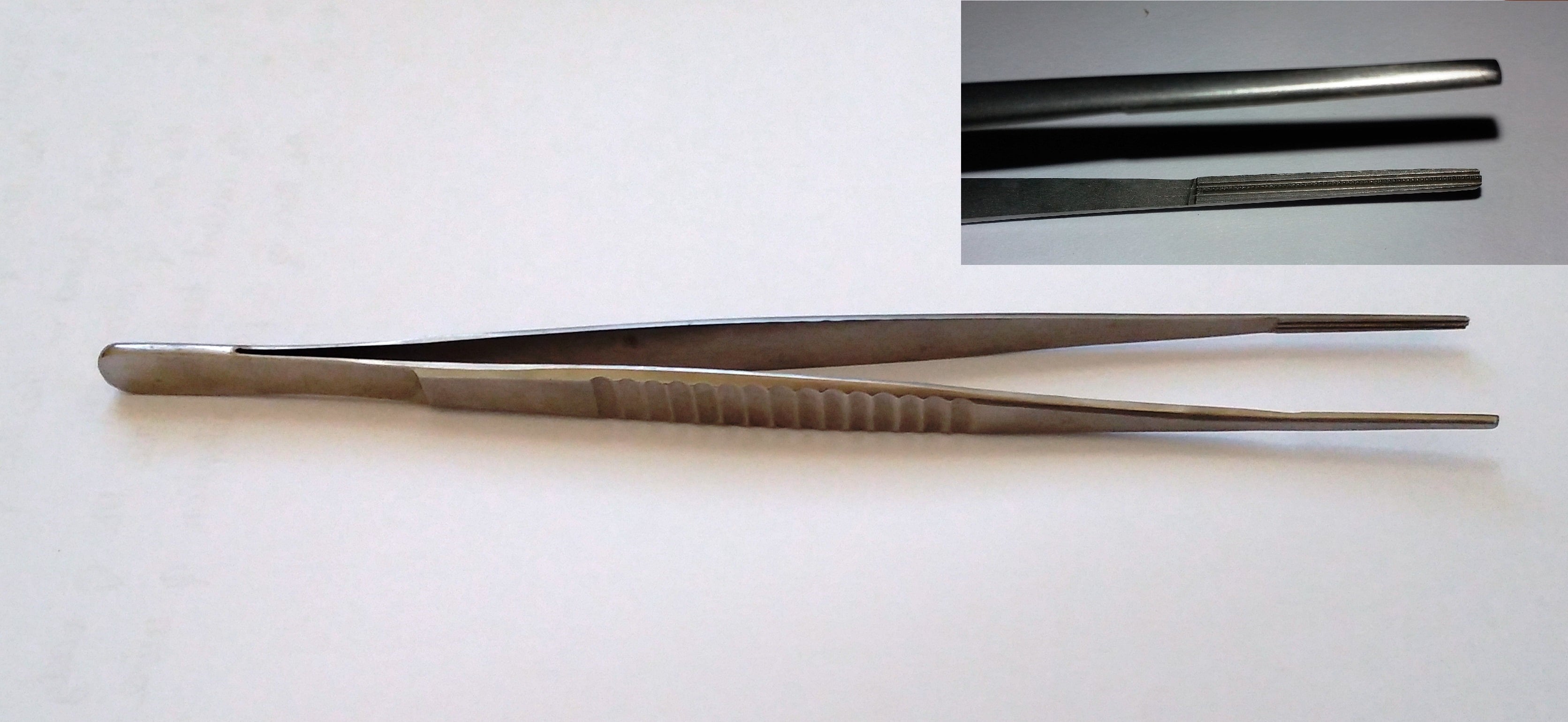 DeBakey atraumatic tissue forceps on a white background with an inset close-up of the ribbed atraumatic tip.