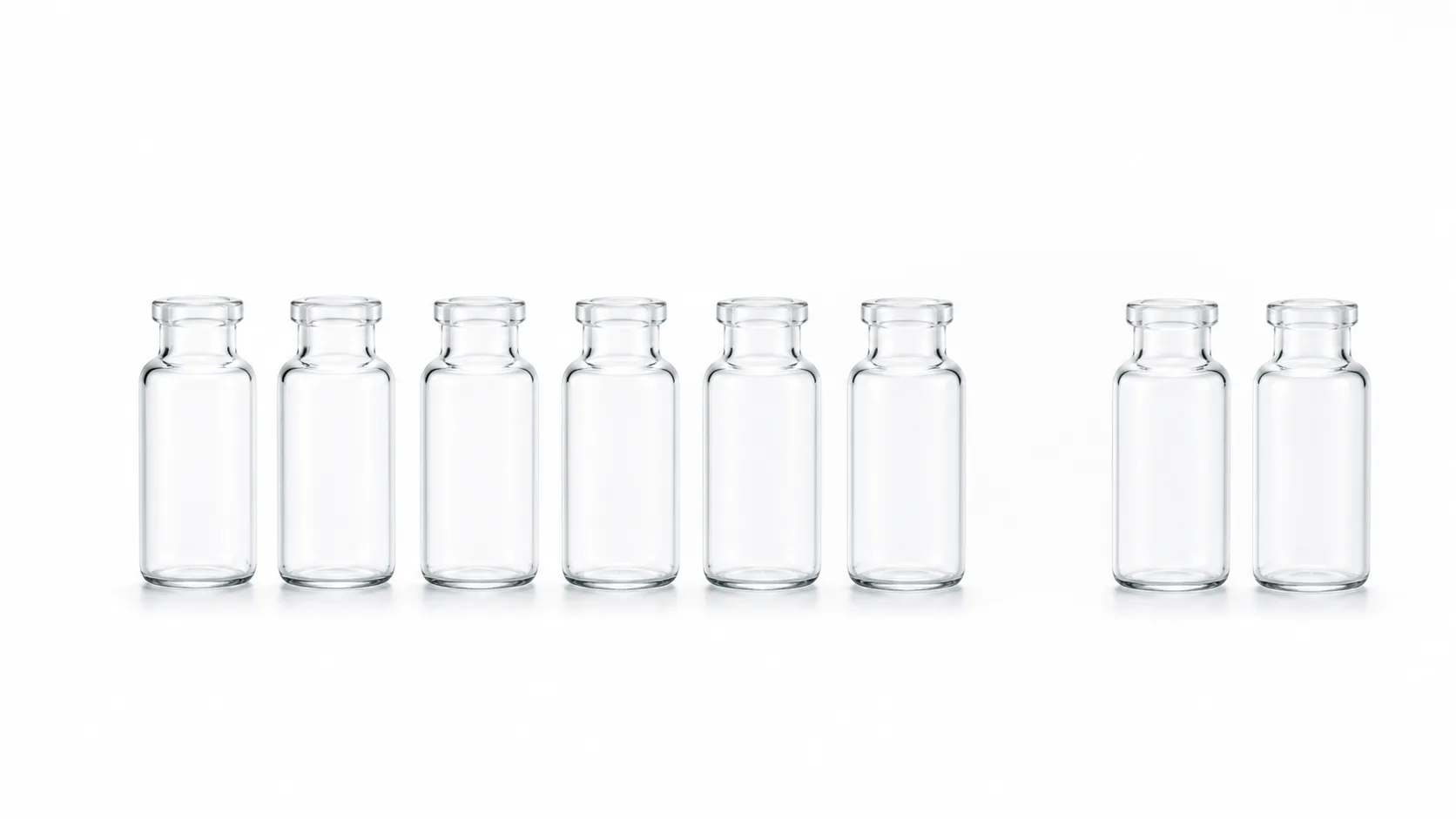 Eight identical small glass vials arranged in a row on a white surface with two of them lifted out and set apart from...
